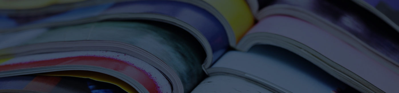 Close up of 7 magazines on top of each other